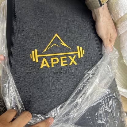Apex Strength Club logo embroidered on a gym bench